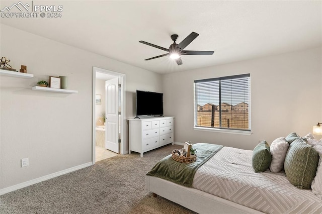 bedroom with ceiling fan, light colored carpet, and connected bathroom