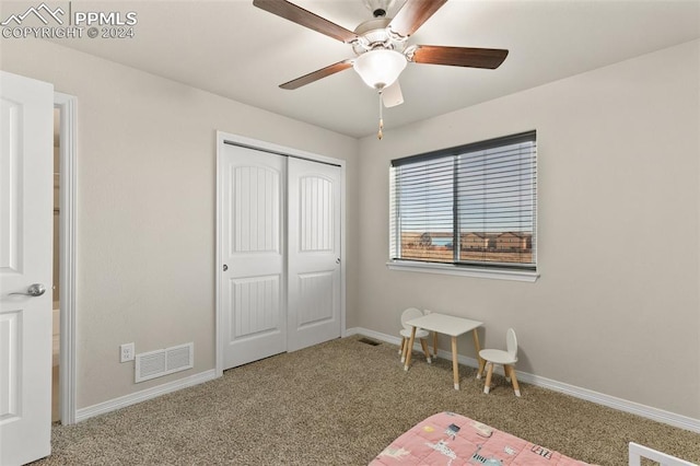 bedroom featuring a closet, ceiling fan, and carpet flooring