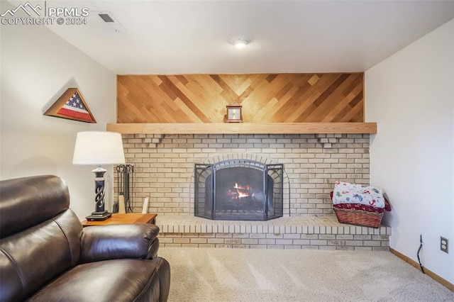 living area featuring carpet, a brick fireplace, baseboards, and wooden walls