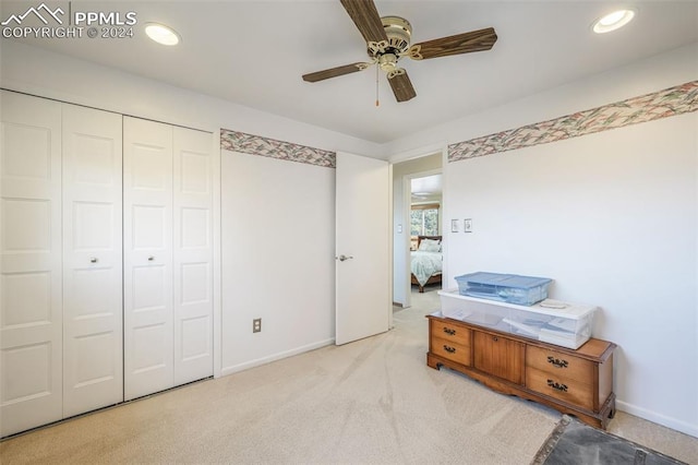 interior space with recessed lighting, light colored carpet, a ceiling fan, baseboards, and a closet