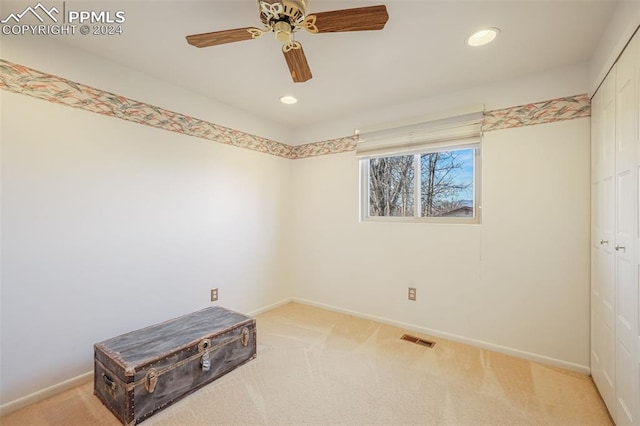 empty room with ceiling fan, recessed lighting, light carpet, visible vents, and baseboards