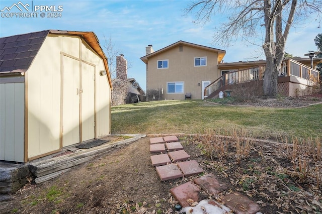 exterior space featuring a storage shed, a deck, stairway, and an outdoor structure