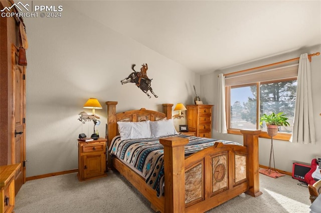 bedroom with light colored carpet and vaulted ceiling