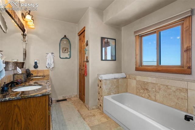 bathroom featuring a washtub and vanity