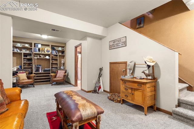 living area featuring built in features and light colored carpet