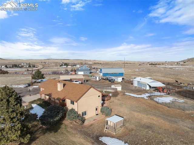 birds eye view of property with a rural view