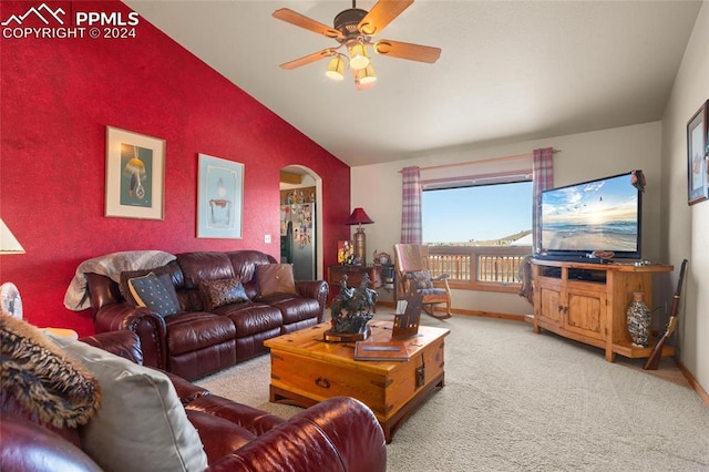 carpeted living room with ceiling fan and lofted ceiling