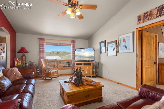 carpeted living room featuring ceiling fan and vaulted ceiling