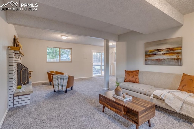 carpeted living room with a fireplace and a textured ceiling