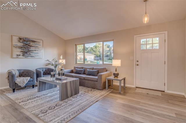 living room with light hardwood / wood-style flooring and lofted ceiling