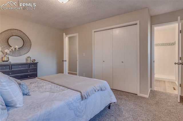 bedroom featuring light carpet and a textured ceiling