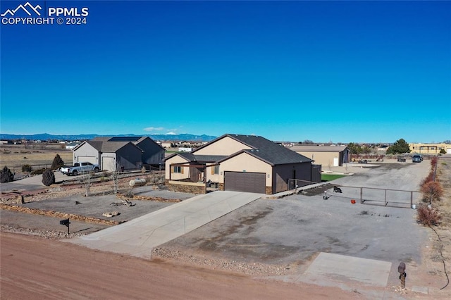 view of front of property with a mountain view and a garage