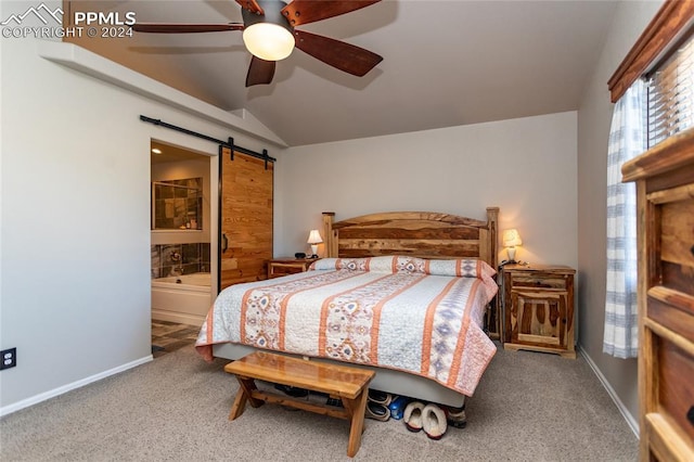 bedroom featuring carpet, a barn door, ceiling fan, and connected bathroom