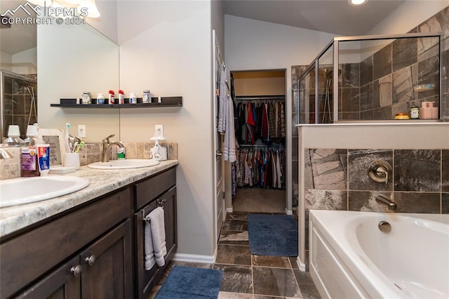 bathroom featuring vanity and shower with separate bathtub