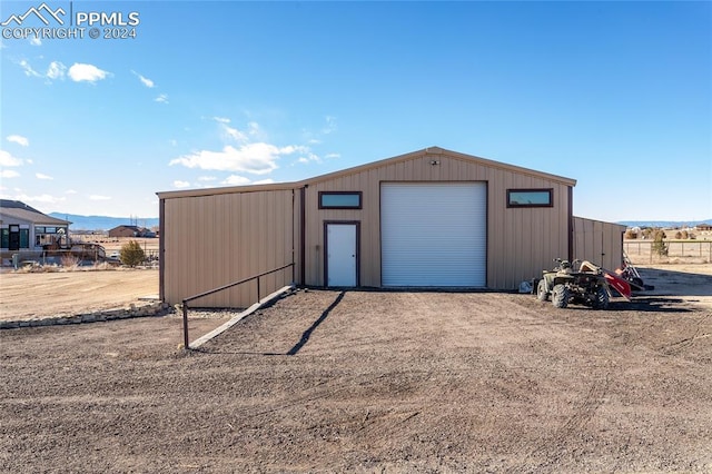 view of outbuilding featuring a mountain view and a garage