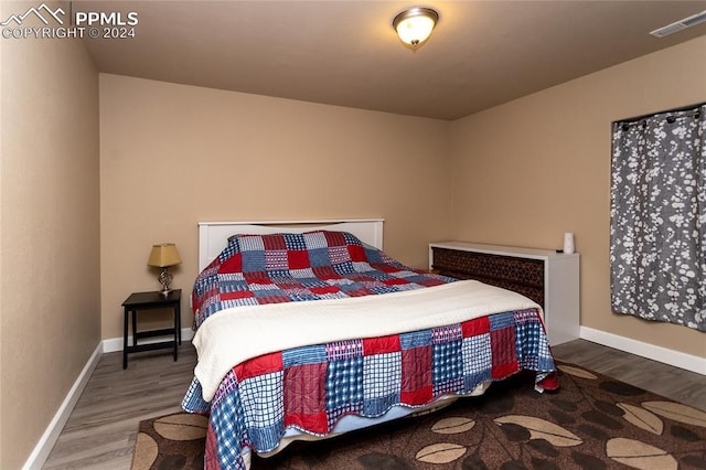 bedroom with wood-type flooring