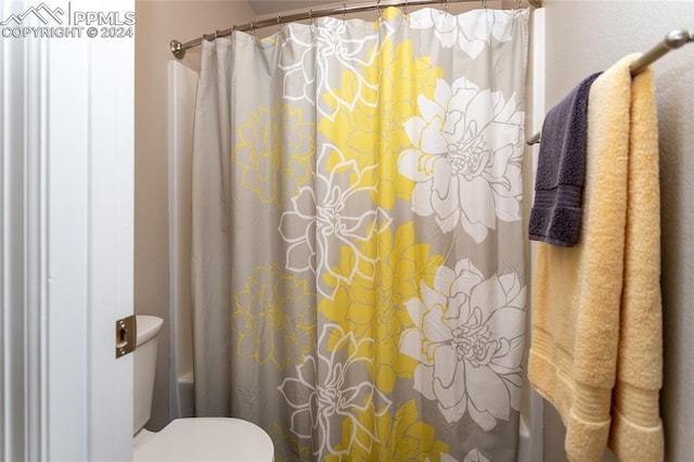 bathroom with shower / tub combo and toilet