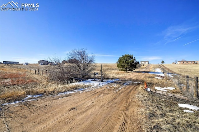 view of yard with a rural view