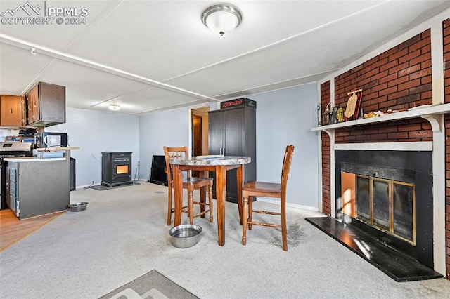 carpeted dining space featuring a brick fireplace