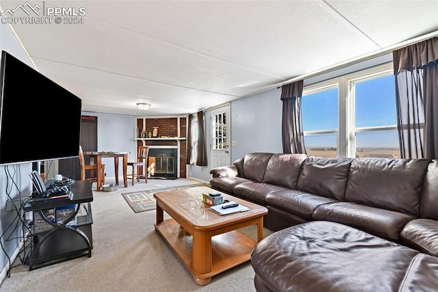 carpeted living room featuring a fireplace
