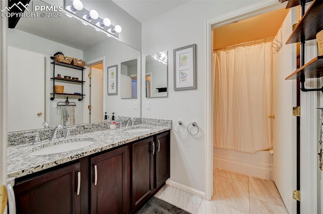 bathroom with tile patterned floors, vanity, and shower / bath combo with shower curtain