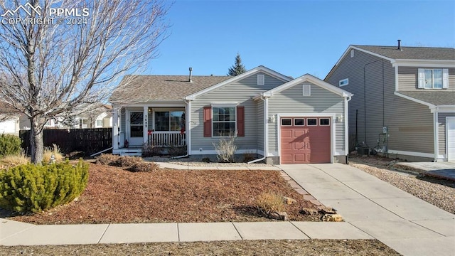 view of front of property with a porch and a garage