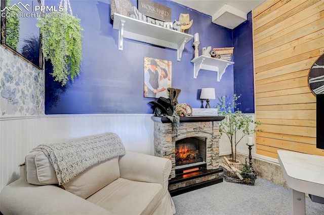 living area featuring carpet flooring and a fireplace