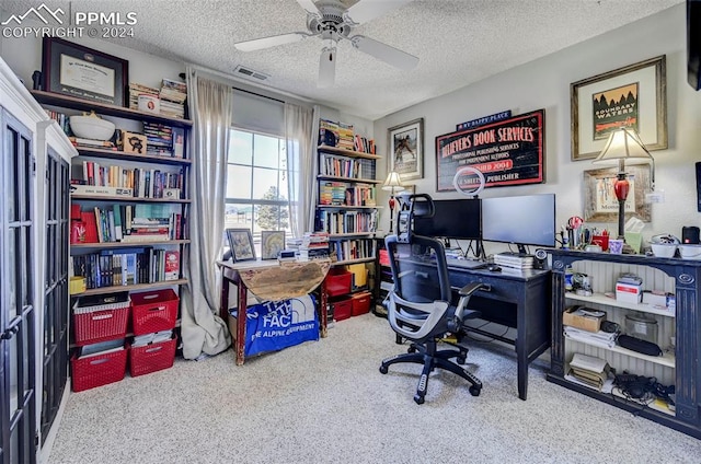 home office with carpet flooring, a textured ceiling, and ceiling fan