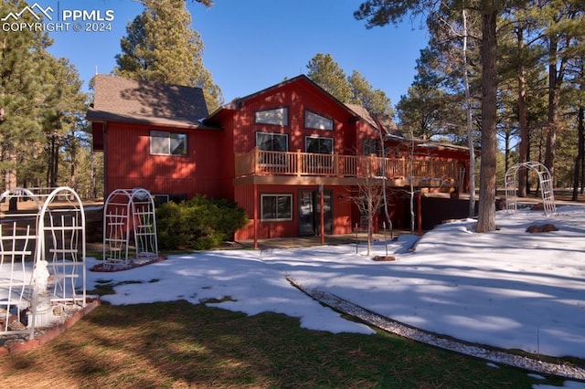 back of property with a wooden deck