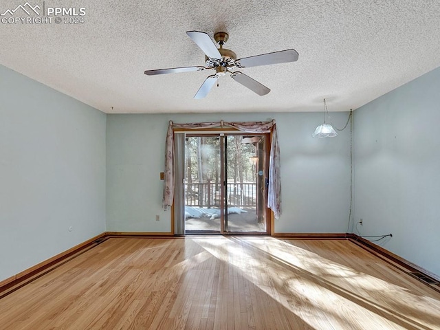 empty room featuring ceiling fan, a textured ceiling, and light hardwood / wood-style flooring