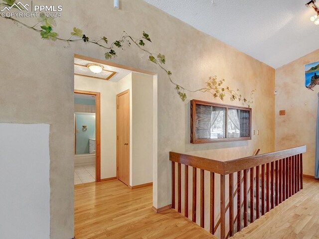 hall with hardwood / wood-style floors