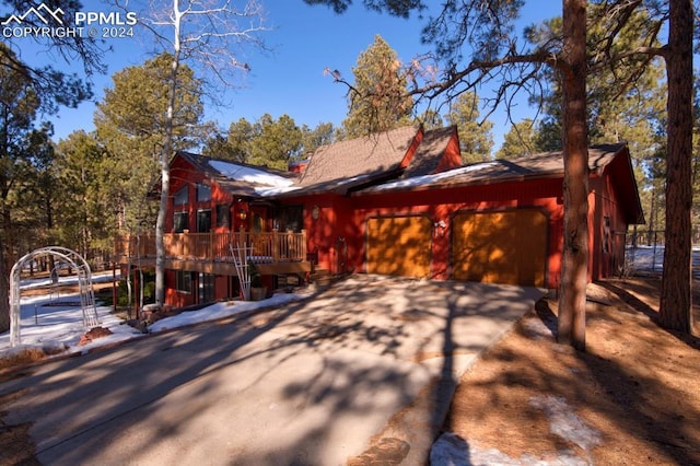 exterior space with a garage and a deck