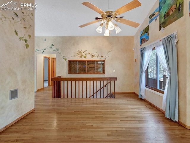 bonus room featuring ceiling fan, light wood-type flooring, and lofted ceiling