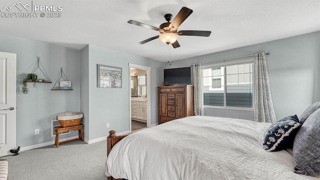 carpeted bedroom with ensuite bath and ceiling fan