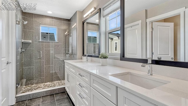 bathroom featuring tile patterned flooring, vanity, and an enclosed shower