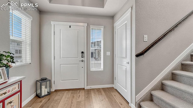 foyer entrance with light hardwood / wood-style floors and plenty of natural light