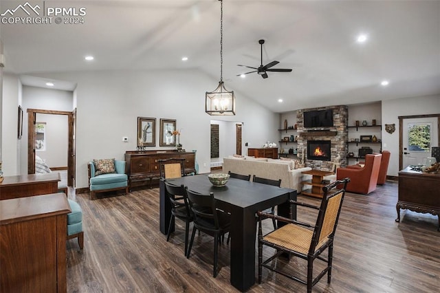 dining area featuring dark hardwood / wood-style flooring, ceiling fan, a fireplace, and lofted ceiling