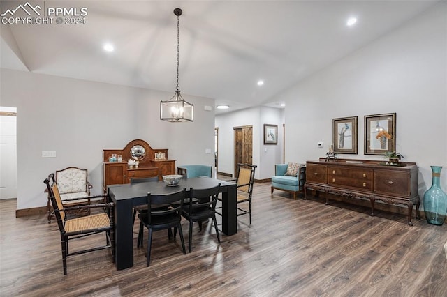 dining area featuring high vaulted ceiling and dark wood-type flooring