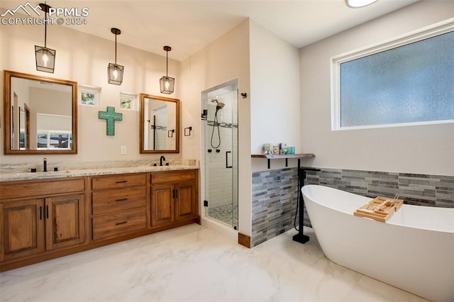 bathroom featuring vanity, plus walk in shower, and tile walls