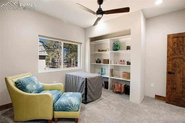 living area with carpet flooring and ceiling fan