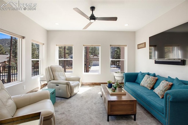 carpeted living room featuring a wealth of natural light and ceiling fan