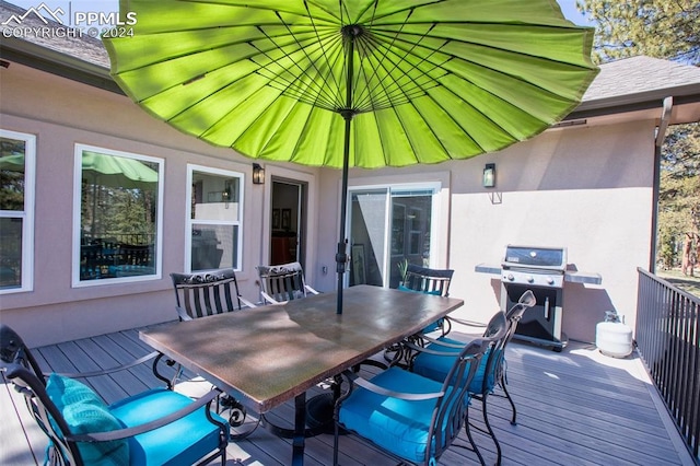 wooden deck featuring a grill