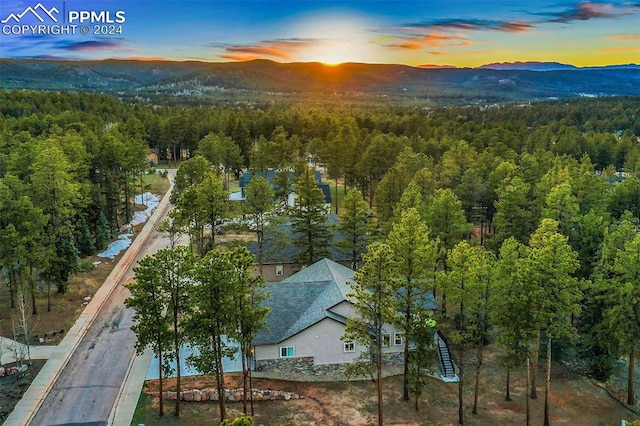 aerial view at dusk featuring a mountain view