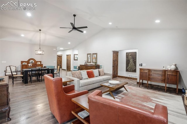 living room featuring ceiling fan, light wood-type flooring, and high vaulted ceiling