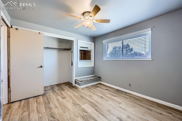 unfurnished bedroom featuring ceiling fan, light wood-type flooring, and a closet