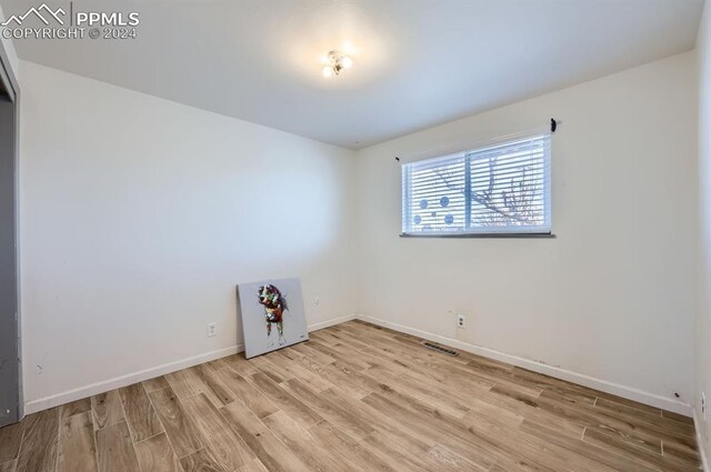 empty room with light hardwood / wood-style floors