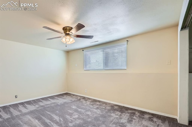 carpeted spare room with a textured ceiling and ceiling fan