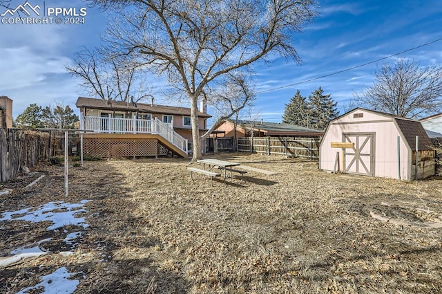 view of yard featuring a shed and a wooden deck