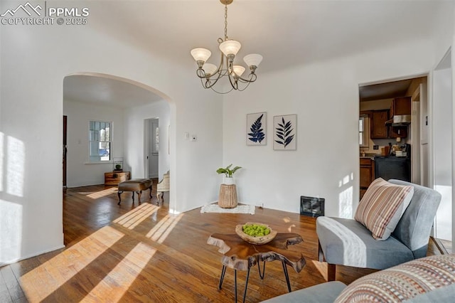 living room featuring dark wood-type flooring and an inviting chandelier