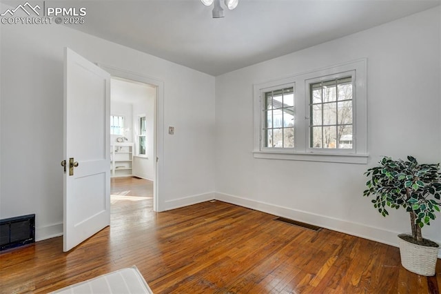 unfurnished room featuring hardwood / wood-style flooring